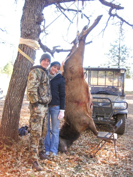 Stefan wilson with his wife and a cow elk