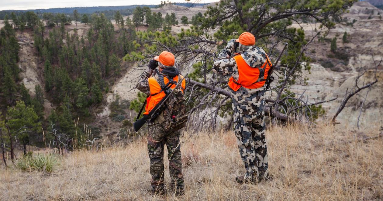 Two hunters glassing for deer 1