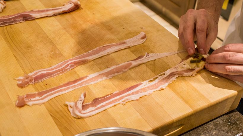 Rolling bacon around elk meat