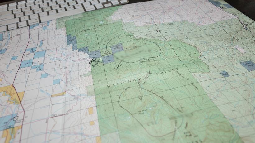 Using a map while calling a biologist for hunting information