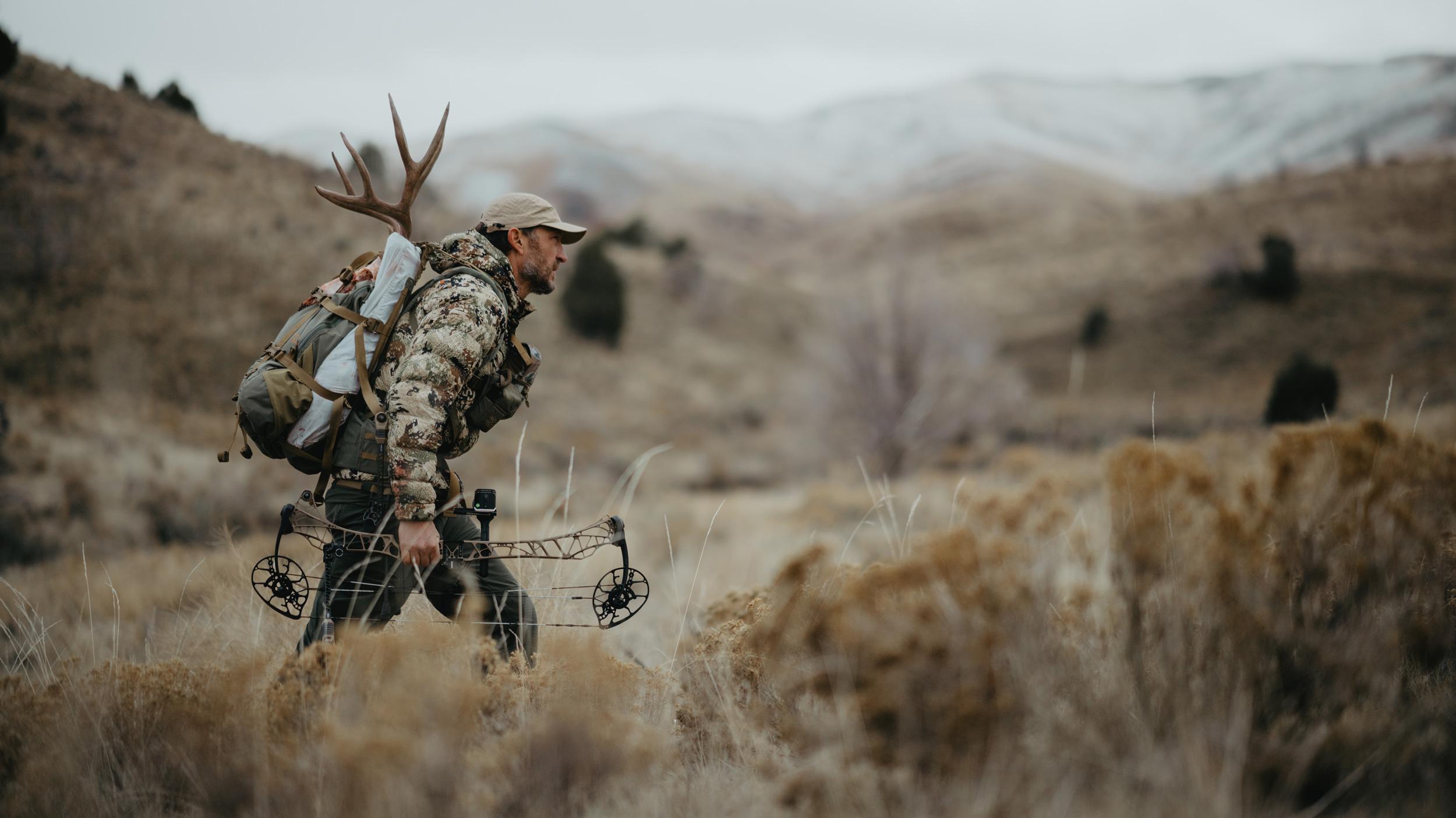 Trail Kreitzer packing out a mule deer with a Mystery Ranch Metcalf 55 backpack