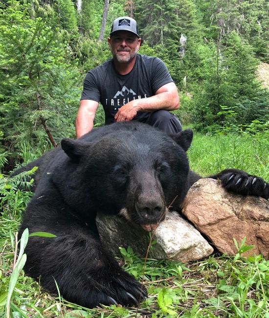 Mark Livesay with a black bear