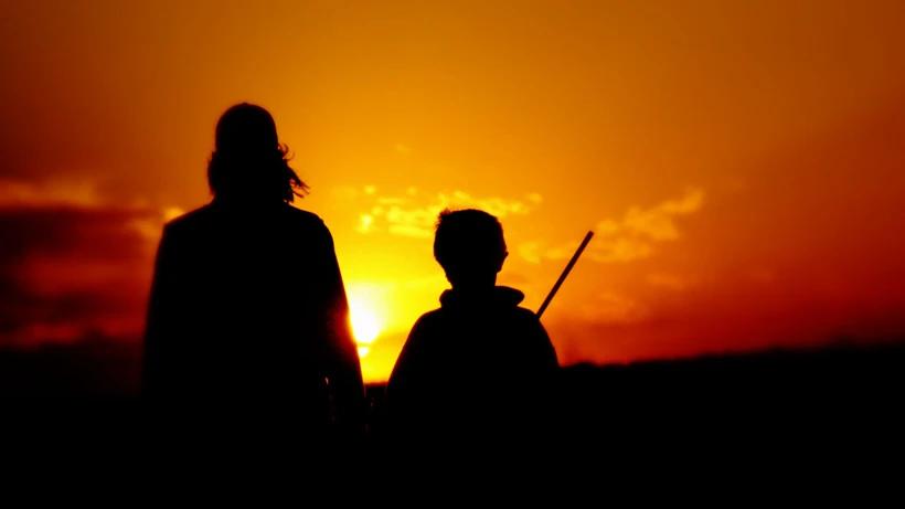 Passing on the tradition youth and adult hunting with sunset