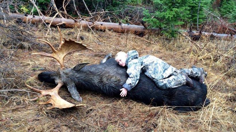 Kayden hugging the wyoming bull moose