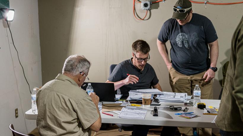 Double checking trophy panel judge score sheets
