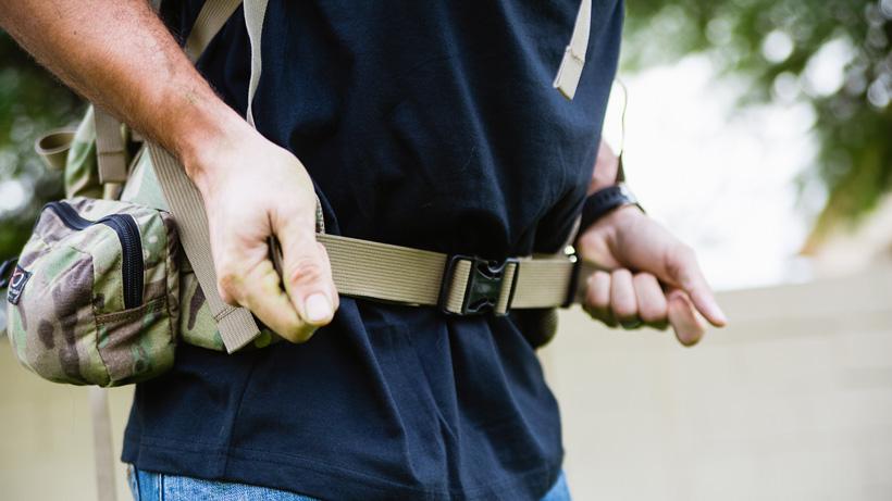 Adjusting the waist belt on a hunting backpack