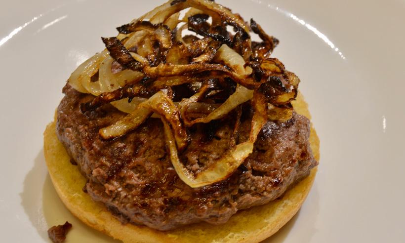 Burger patty with grilled onions
