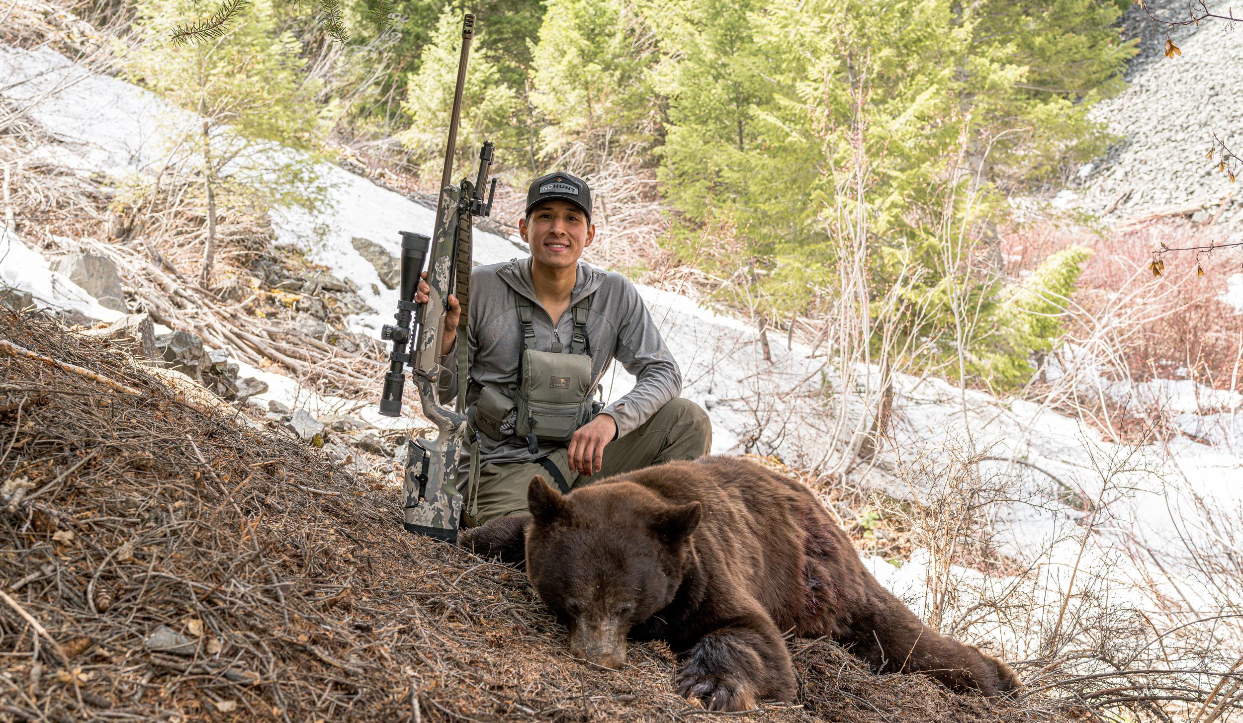 Omar Lopez with a black bear he took with a Browning X-Bolt 6.8 Western rifle