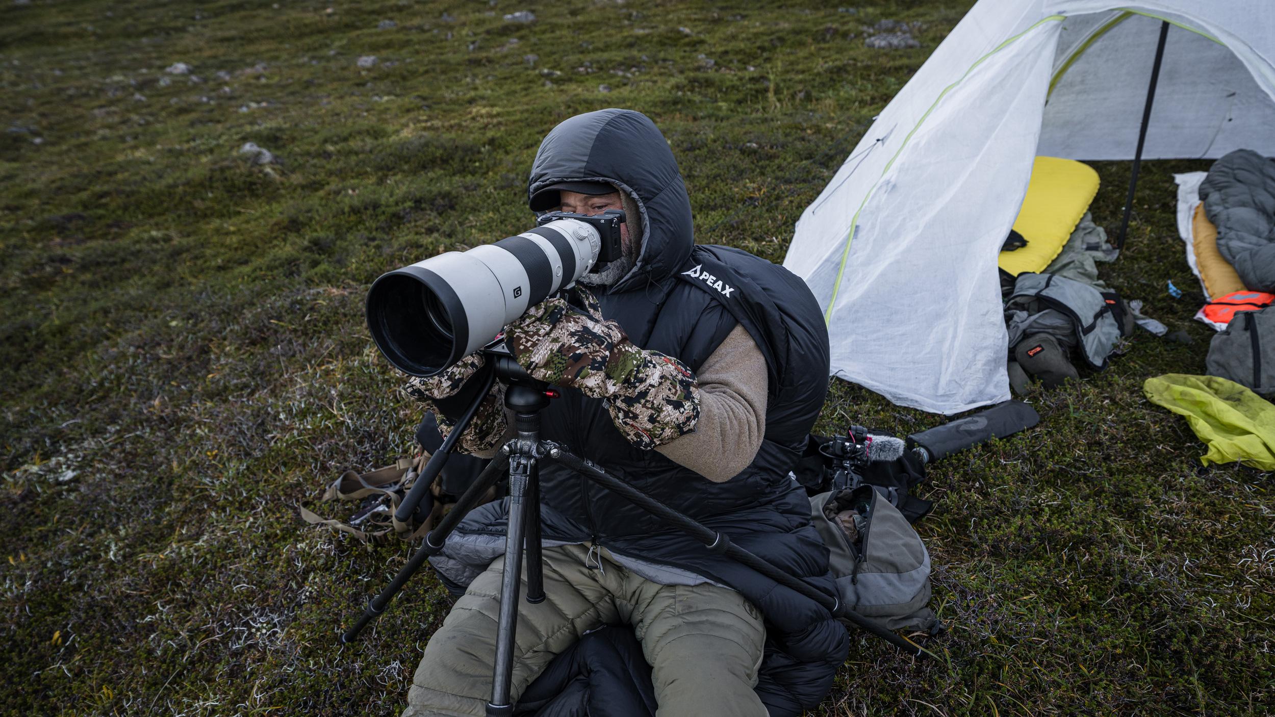 Brian Call taking photos while staying warm inside the PEAX Solace 15 sleeping bag