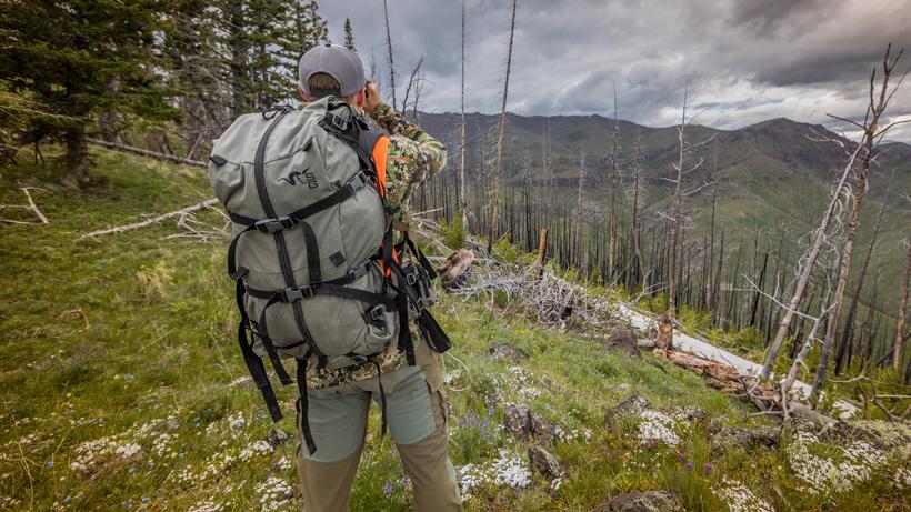 Hunter comfortably navigating downhill slope because of an organized backpack