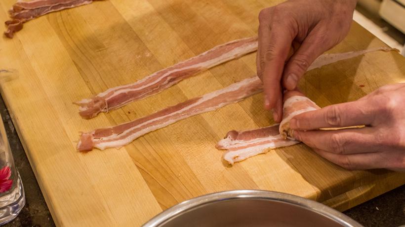 Continue wrapping bacon around ingredients