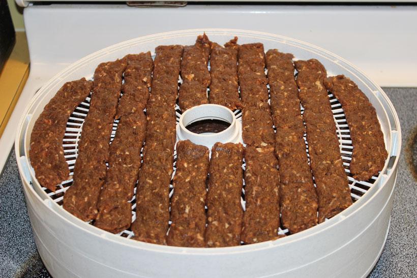 Meat placed on dehydrater trays 9