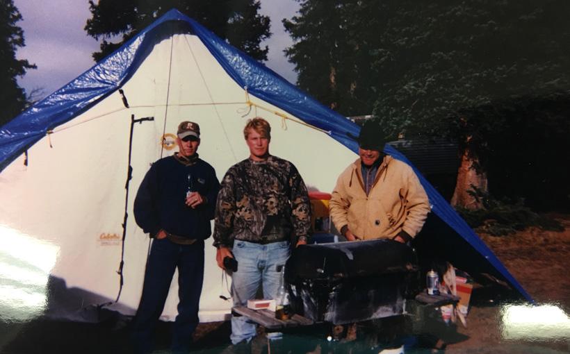 Old elk hunting photo near a wall tent