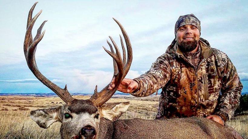 Us veteran with a harvested mule deer in Idaho