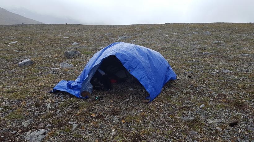 Tarp to protect gear during rainstorm