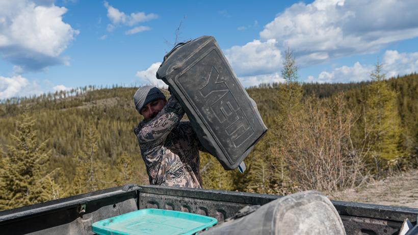 Tossing yeti panga 75 duffel of gear in truck