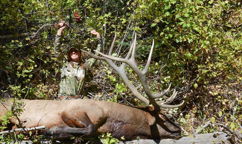 Kim mills celebrating after taking an archery bull elk