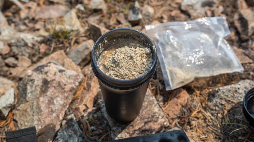Making breakfast protein shake on the mountain