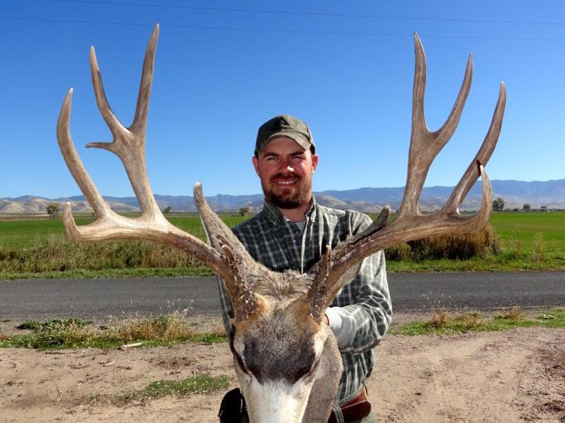 Kevin with a giant idaho mule deer taken with bearpaw outfitters