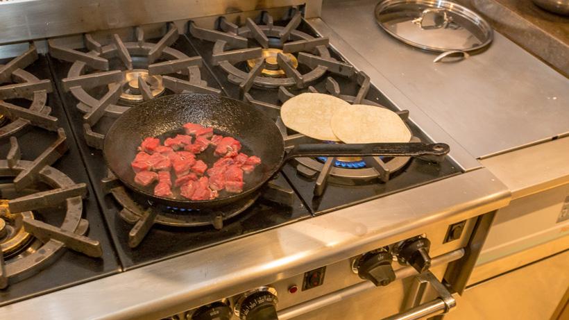 Cooking the elk meat and heating tortillas
