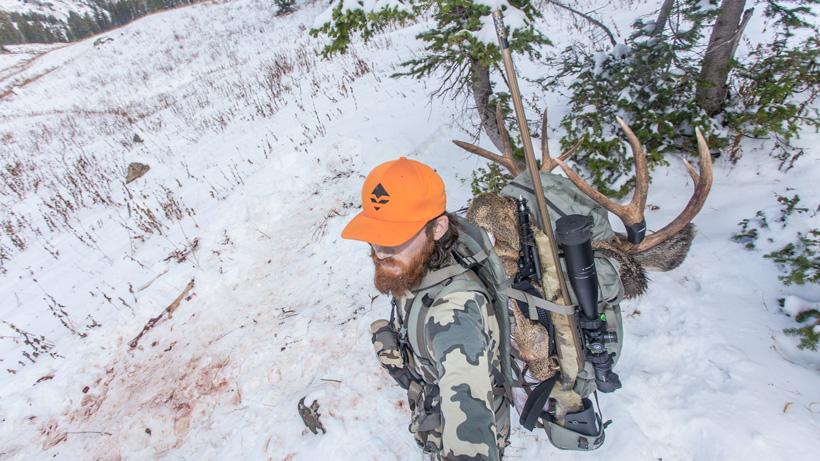 Solo packing out deer meat in backpack