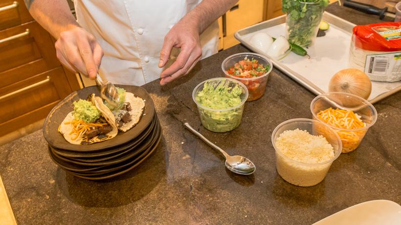 Adding ingredients to elk tacos