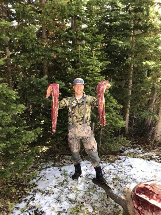 Justin holding up elk backstraps