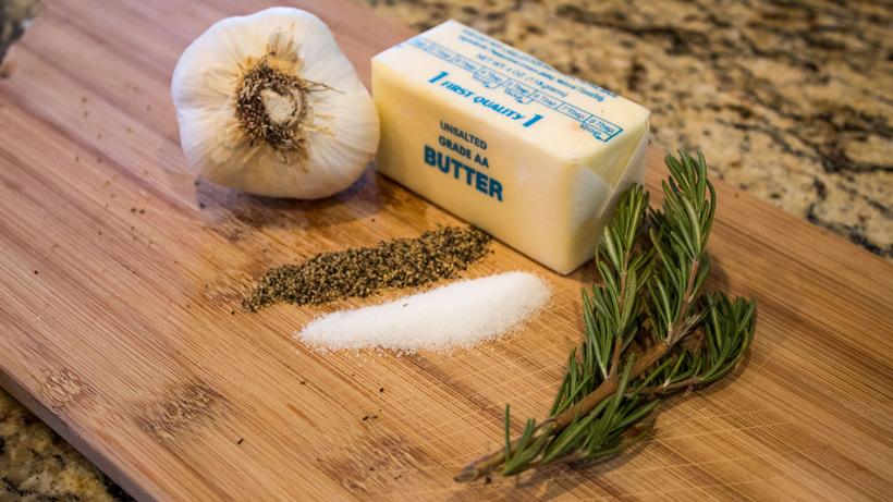 Combining butter garlic and rosemary for elk roast