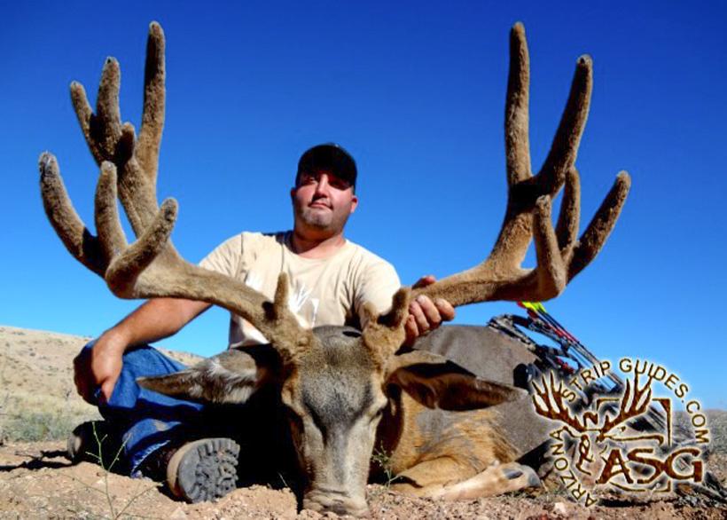 Glenn with a giant velvet arizona archery mule deer taken with arizona strip guides