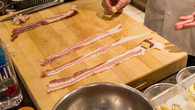 Lay ingredients on bacon slice then roll